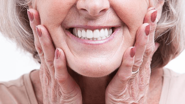 Senior woman with dentures showing off her smile