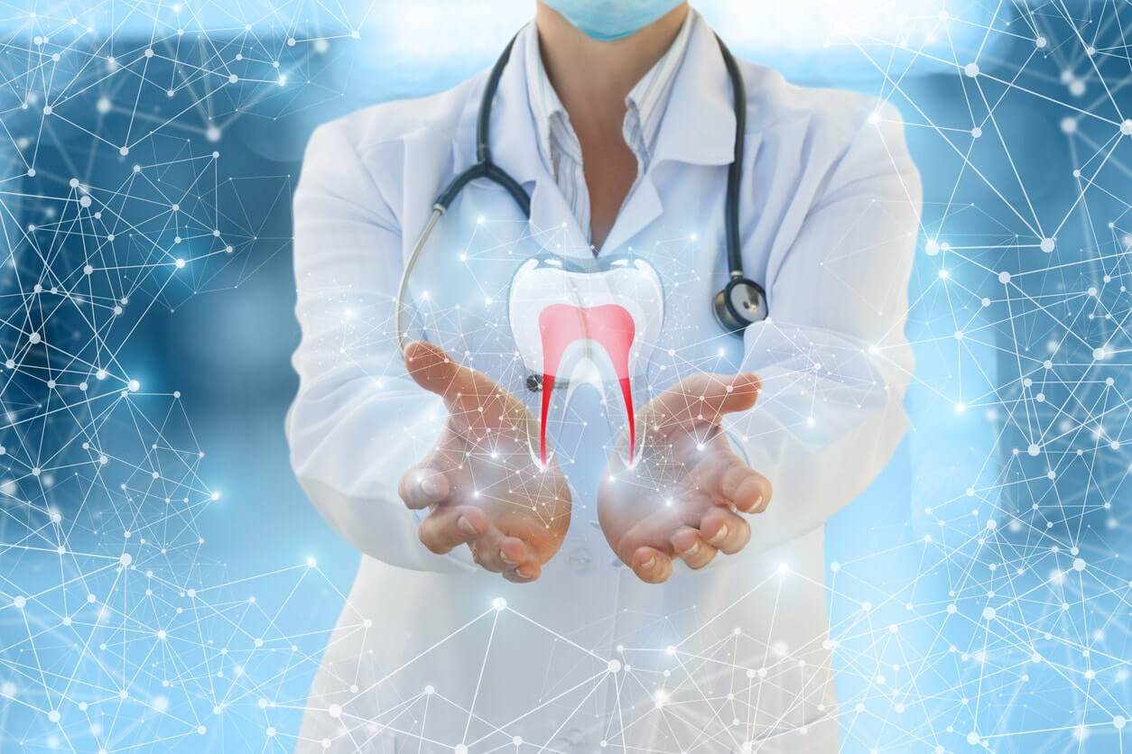 Dentist with hands out, translucent tooth in her hands, blue background with bright lights