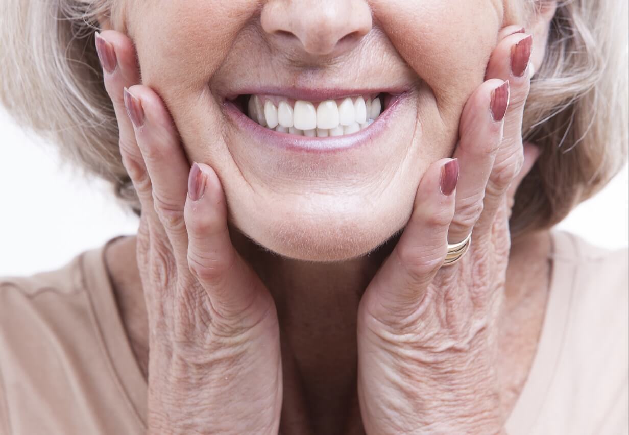 Senior woman with dentures showing off her smile