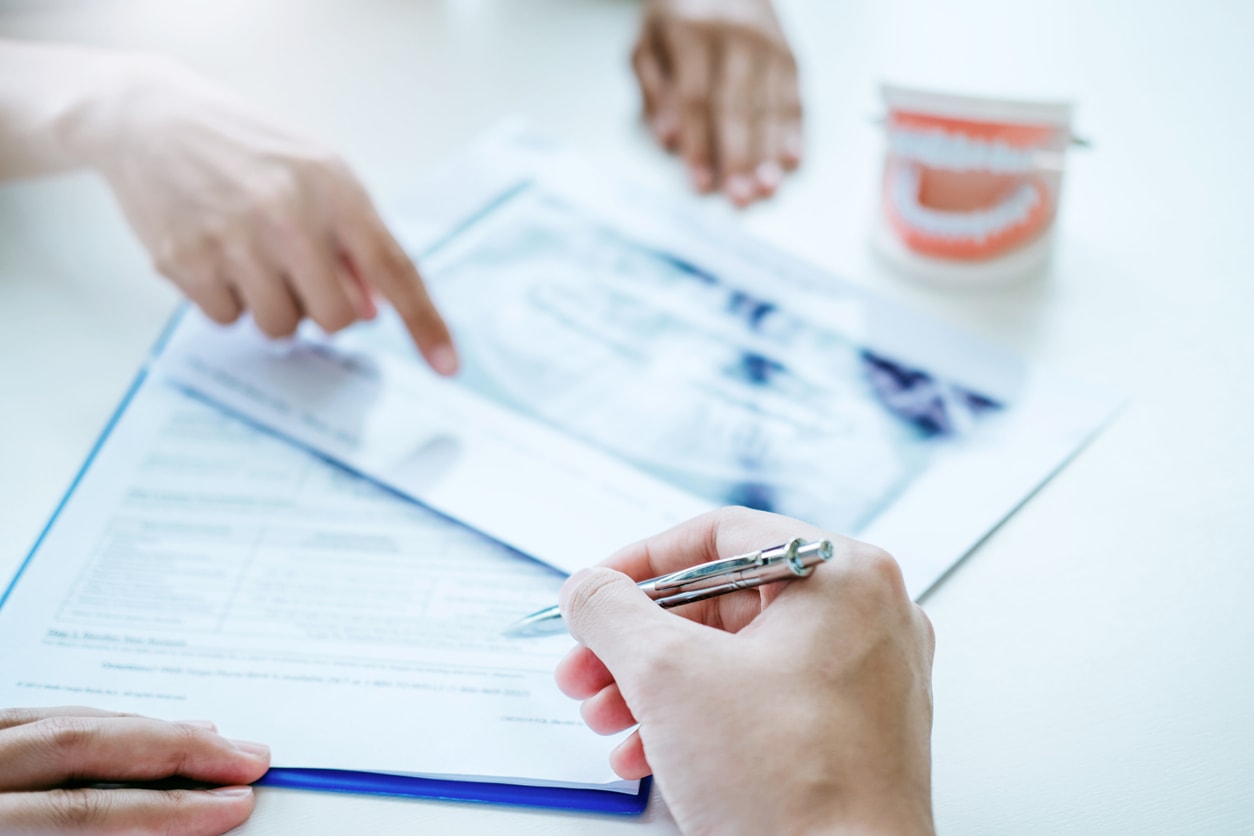 Dentist consulting with patient presenting results on Dental x-ray film About the problem of the patient