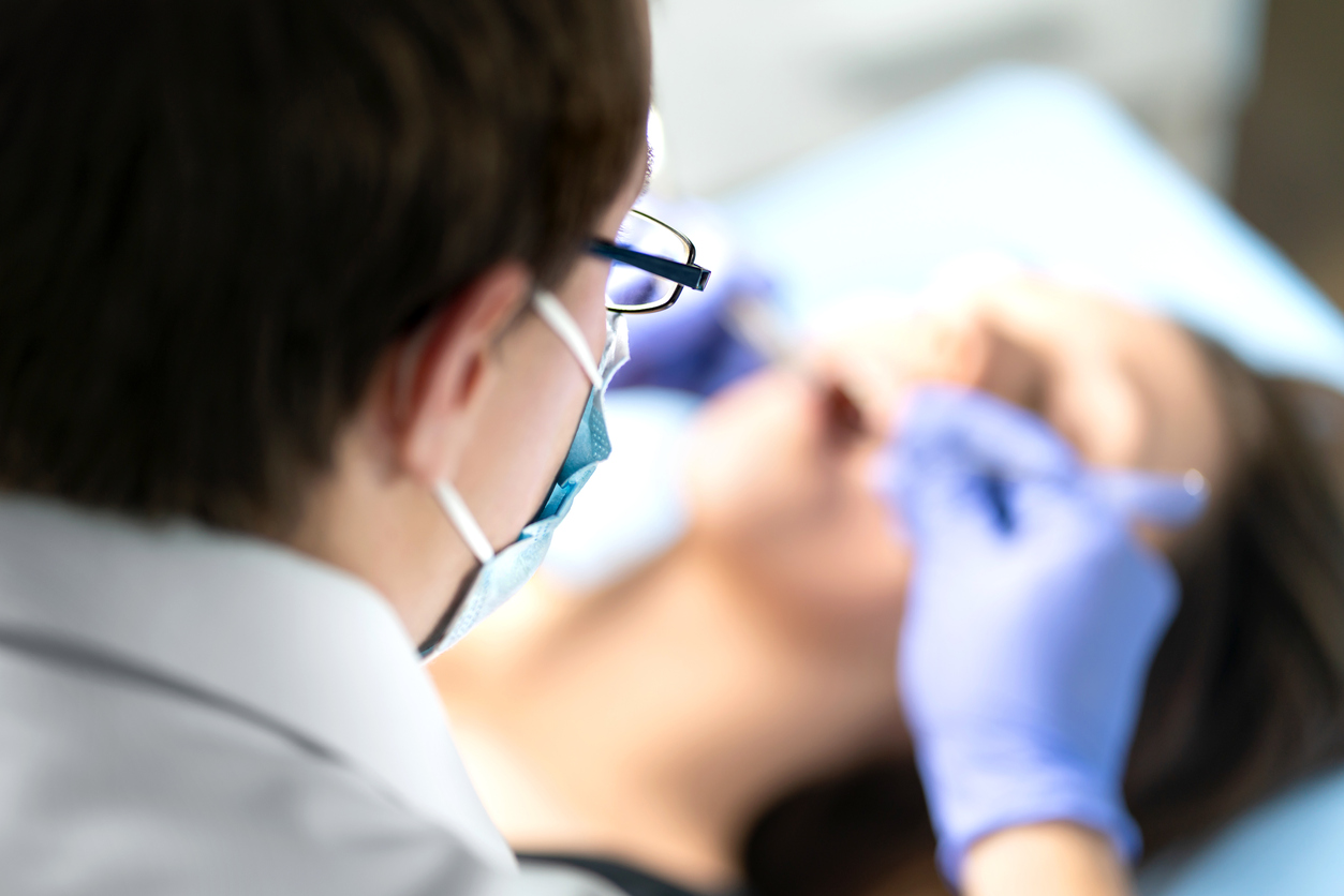 Dentist performing tooth extraction